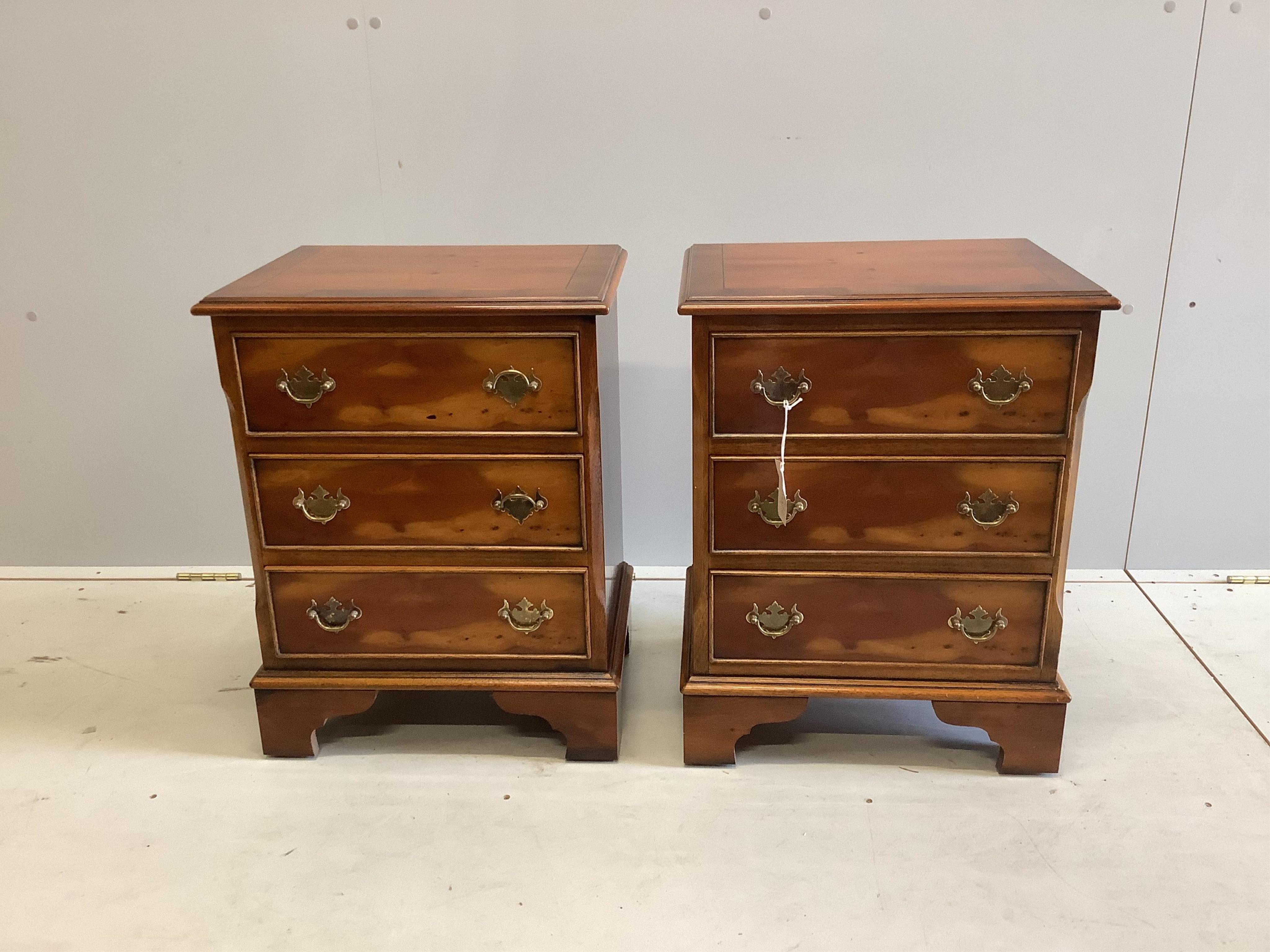 A pair of reproduction yew three drawer bedside chests, width 46cm, depth 35cm, height 60cm. Condition - good